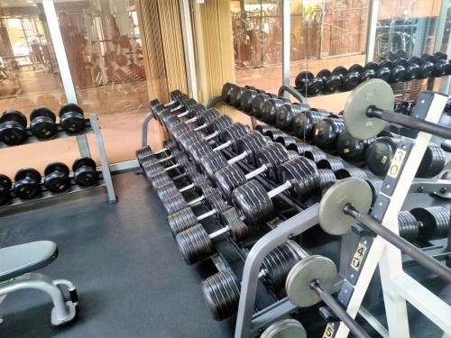 a row of dumbbells in a gym at Almond Business Hotel in Nicosia