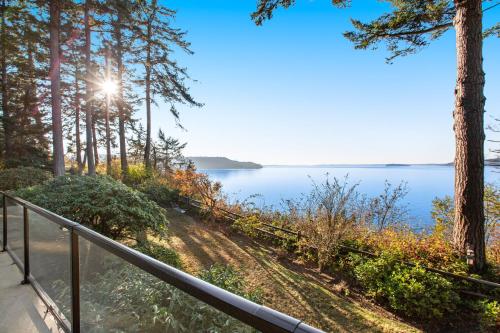 a balcony with a view of a lake at Sunset Getaway in Utsalady