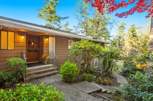 a small house with a porch and stairs at Sunset Getaway in Utsalady