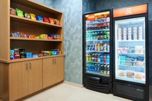 a refrigerator filled with lots of drinks in a store at Holiday Inn Express Hotel & Suites Port St. Lucie West by IHG in Port Saint Lucie