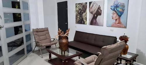 a living room with a couch and two chairs at Balcones al Mar by La Marina in Ríohacha