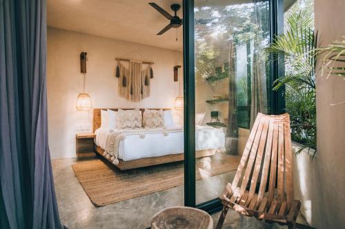 a bedroom with a bed and a sliding glass door at Round Luxury Villa Private Pool Soona 4A in Tulum