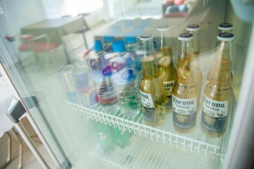a refrigerator filled with lots of bottles of beer at Hotel Anmara in San Juan
