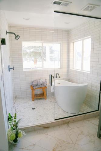a bath tub in a bathroom with a glass door at Homestead Resort in Midway