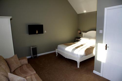 A bed or beds in a room at The Bull Inn Lodges 