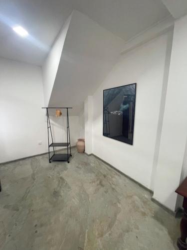 a white room with a painting on a wall at Komox Gedara in Galle