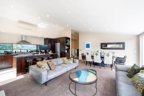 a living room with a couch and a table at Luxury Lakeview Vista Apartment in Wanaka