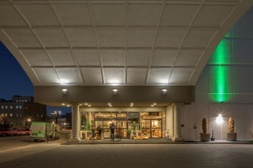 a building with a green light at night at Holiday Inn Portland-By the Bay by IHG in Portland
