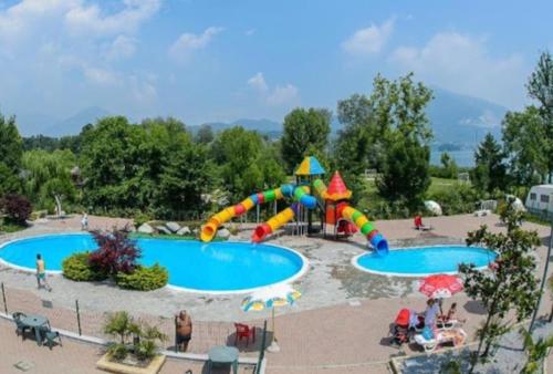 a water park with two pools and a slide at LA CASA DEL SOLE in Merone