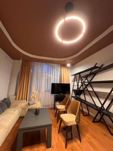 a living room with a couch and a bed and a table at Artist Apartment in Braşov