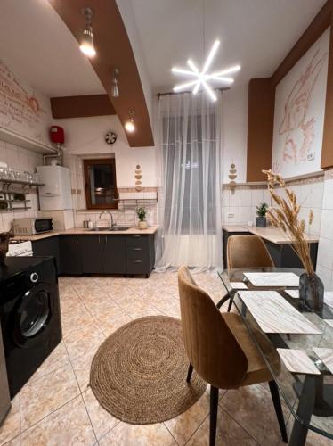 a kitchen with a table and a dining room at Artist Apartment in Braşov