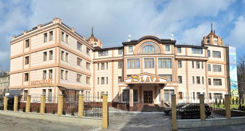 a large building with a clock on the front of it at Slava Hotel in Zaporozhye
