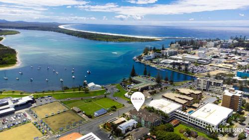 an aerial view of a city and a body of water at Westport Palms 2 in Port Macquarie