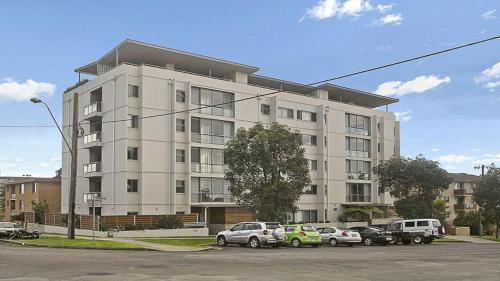 a large building with cars parked in front of it at Plaza 14 in Port Macquarie