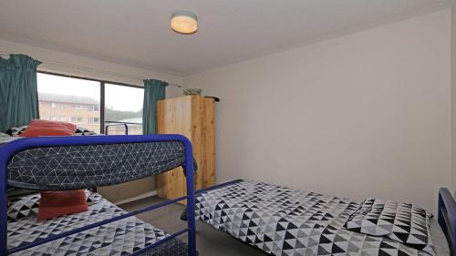 a bedroom with two bunk beds and a window at Berdella Park 9 in Port Macquarie