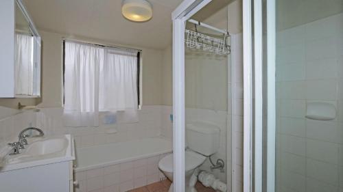 a bathroom with a toilet and a sink and a shower at Berdella Park 9 in Port Macquarie