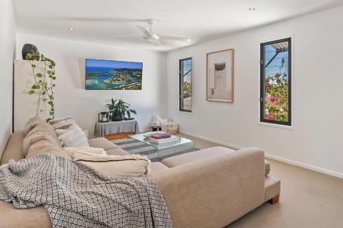 a living room with a couch and a table at Relaxed Luxury In Paradise - A touch of Breeze! in Sunrise Beach