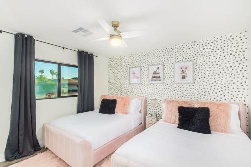 a bedroom with two beds and a window at Scottsdoll Dreamhouse Walk to Old Town NEW in Scottsdale