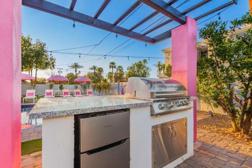a outdoor kitchen with a stove and a patio at Scottsdoll Dreamhouse Walk to Old Town NEW in Scottsdale