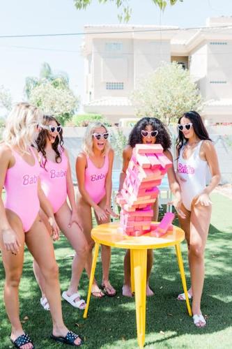 a group of women in pink suits standing around a table with a cake at Scottsdoll Dreamhouse Walk to Old Town NEW in Scottsdale