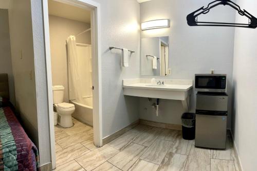 a bathroom with a sink and a toilet at Emerald Best Motel in Edmonds