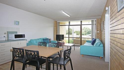 a kitchen and living room with a table and chairs at Pacific 2 in Port Macquarie