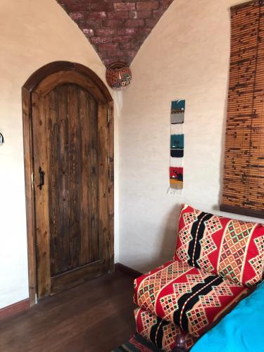 a room with a door and a bed with a pillow at Siwa Spot in Siwa