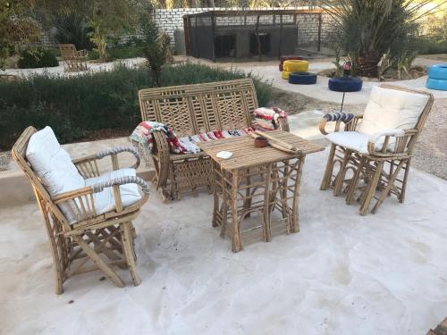 a group of chairs and a wooden table and chairs at Siwa Spot in Siwa