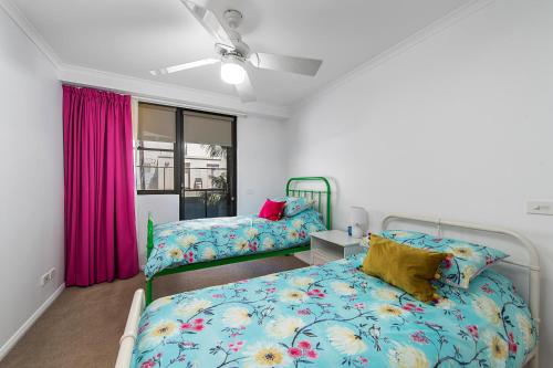 a bedroom with two beds and a window at Flightdeck 203 5-7 Clarence Street PM in Port Macquarie