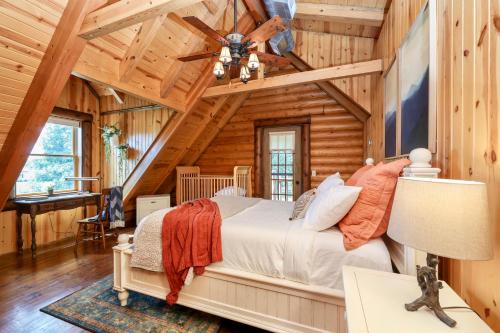 a bedroom with a bed in a log cabin at Rustic Cabin with seasonal Pool & Fire Pit - close to to Bike Path in Celina