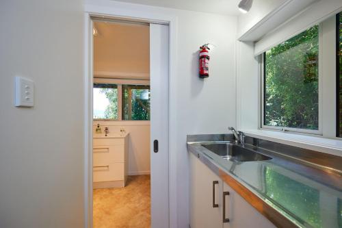 a kitchen with a sink and a window at Ocean & Mountain Views Spacious Home in Kaikoura