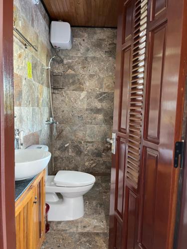 a bathroom with a toilet and a sink at Lakeside Homestay in Hoi An