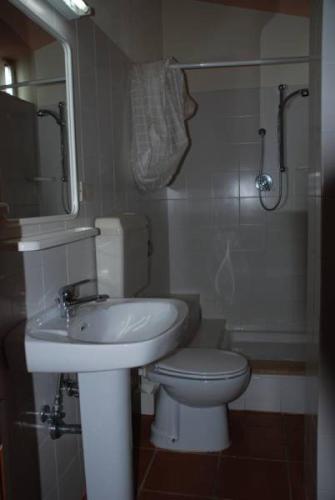 a bathroom with a white sink and a toilet at Al Vecchio Convento in Orosei