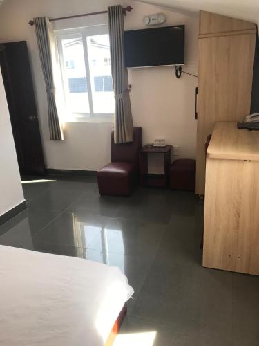 a hotel room with a bed and a window at Tuyet Son Hotel in Da Lat
