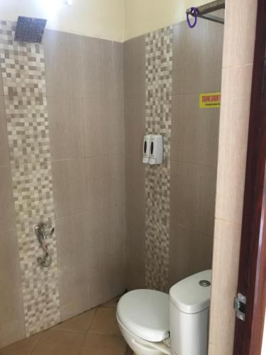 a bathroom with a toilet and a shower at Harys homestay in Triwung