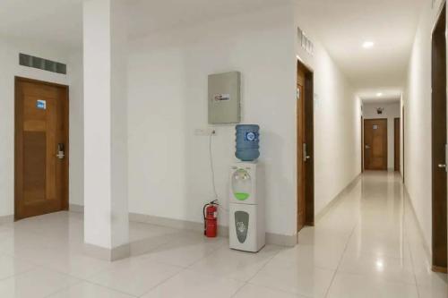 a hallway of a hospital with a water dispenser on the wall at RedDoorz Plus @ Cemara Asri Medan in Pulauberayan Dadap