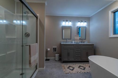 a bathroom with a glass shower and a sink at Charming Corner Newly Furnished Townhome in Lake Harmony