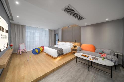 a bedroom with a bed and a couch and a table at Lanshan Moon Resort in Yangshuo
