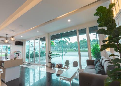 a living room with a couch and a table at Tiny Krabi Hotel in Ban Khlong Chi Lat