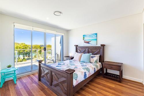 a bedroom with a bed and a large window at The Shoal 503 Avra Seabreeze in Shoal Bay
