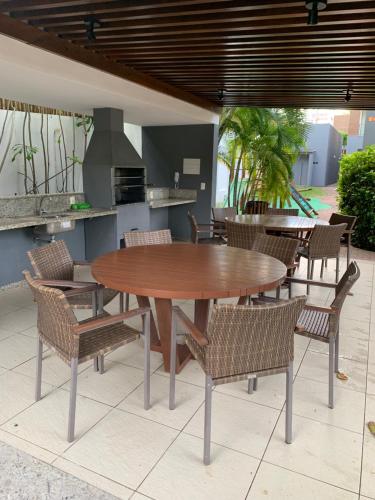 a wooden table and chairs in a patio at Imbassaí Solaris Ap Beach in Imbassai