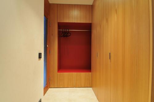 a closet with a red door and a red shelf at Ferienhaus S11 Lustenau in Lustenau