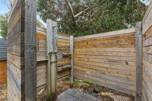 a wooden fence with a water meter on it at Seaside Escape, Margaret River ~ Perfect for Families in Prevelly