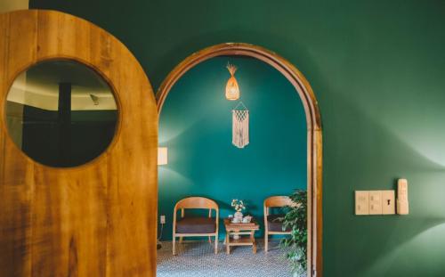a room with a mirror and a table and chairs at Orchard Home Nam Cat Tien in Cat Tien