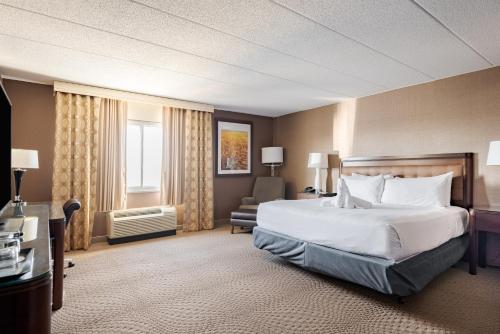 a hotel room with a large bed and a window at Wyndham Omaha Hotel - West Dodge in Omaha
