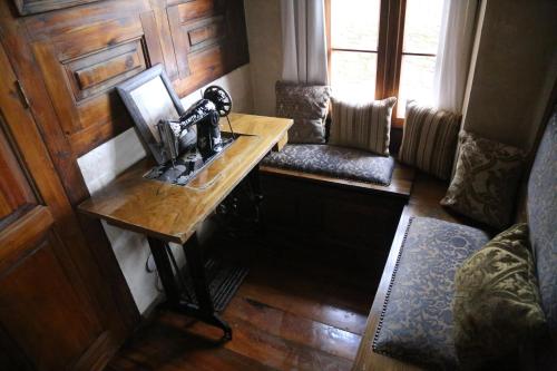 a room with a sewing machine on a wooden table at Nisanyan Hotel in Selcuk