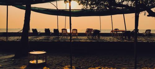 a group of chairs and tables on the beach at Samsun Pride in Chaoka