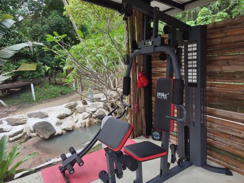 - une salle de sport avec une chaise en face de la piscine dans l'établissement Peace home kpg, à Baan Khai