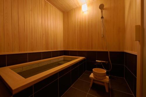 a bathroom with a tub and a toilet in it at RITA Izumo Hirata in Izumo