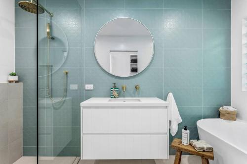 a bathroom with a white sink and a mirror at Swell Jervis Bay in Vincentia